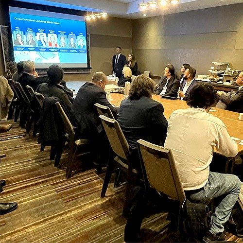 Participants at the 2024 AIAC conference sitting around a conference room table