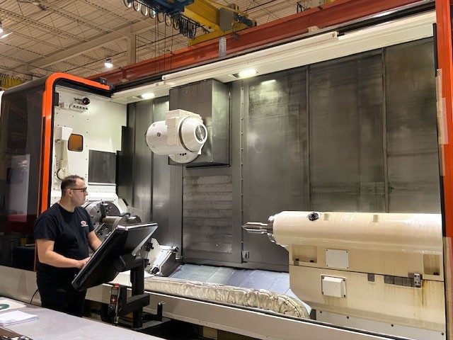 LHM Technologies employee working at a large tablet